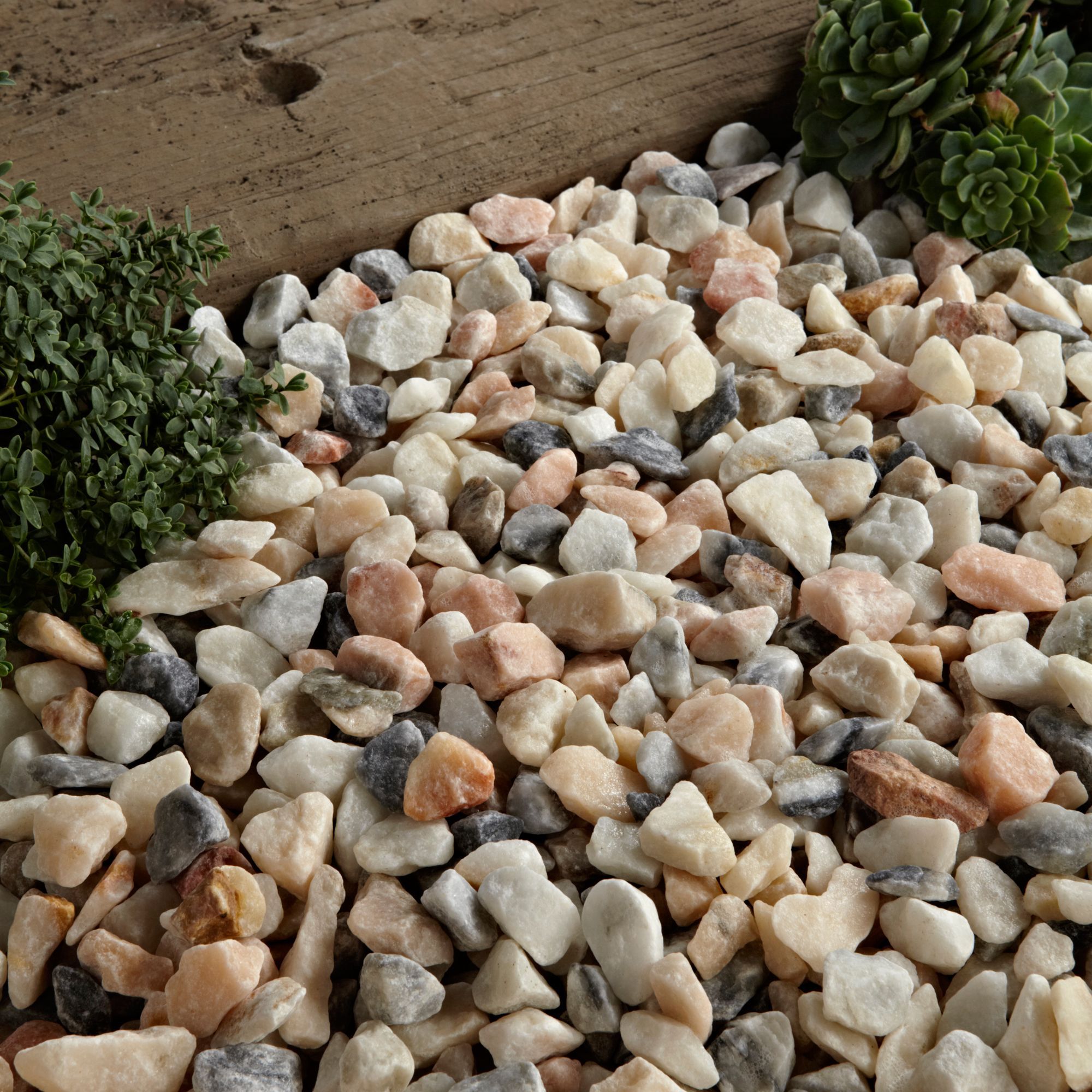 Table decorated with popular mosaic tiles and pebbles pink - grey