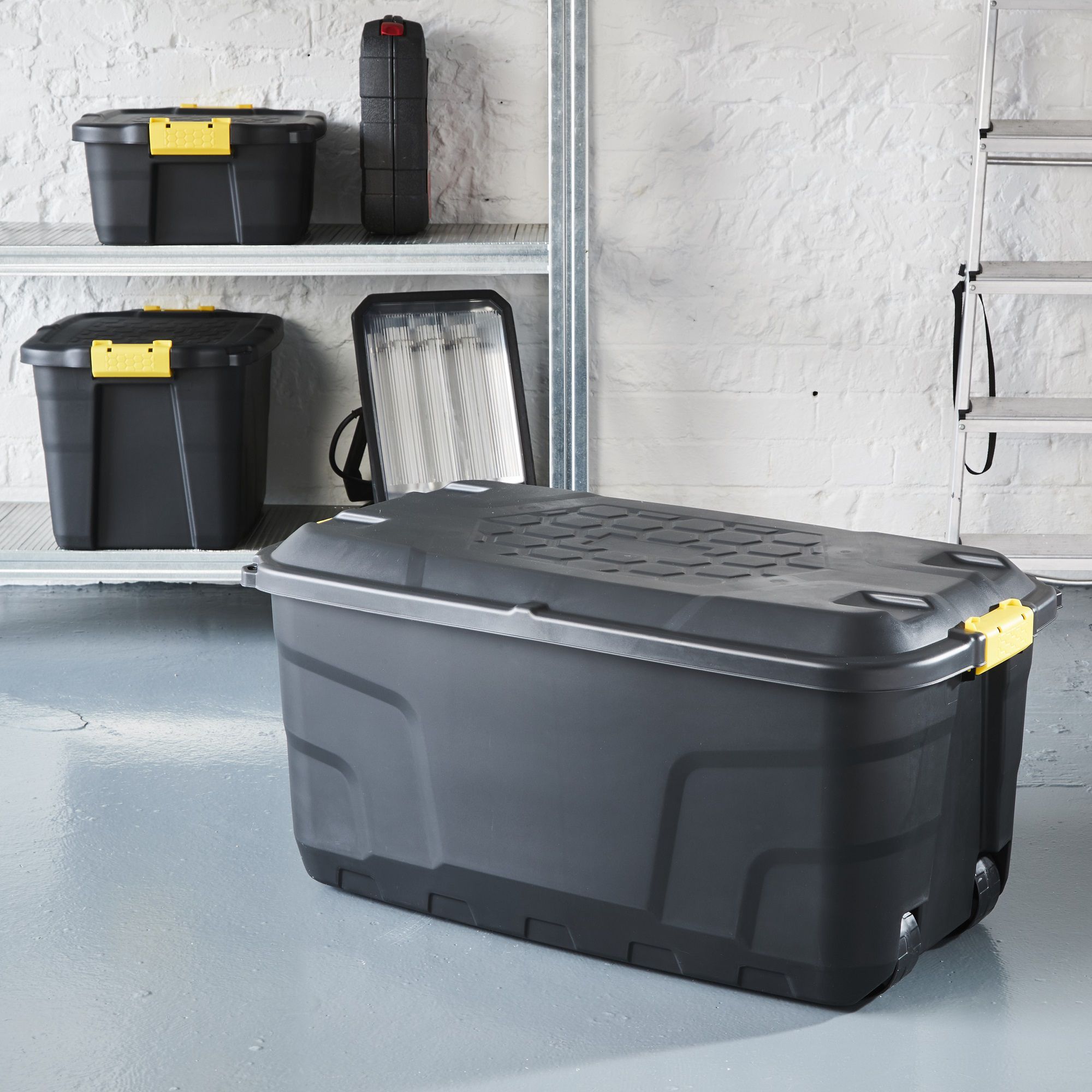 Strata Heavy duty Black 145L Large Plastic Stackable Wheeled Storage trunk with Lid
