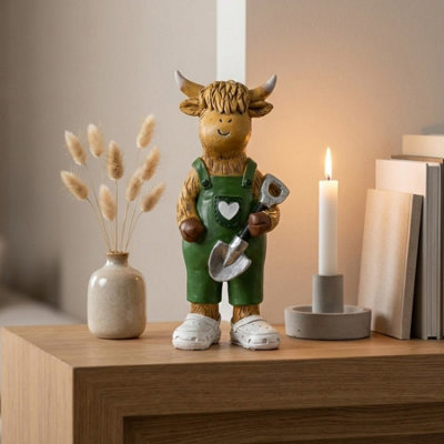 Garden Greatness Highland Cow Holding Shovel Ornament from B&Q