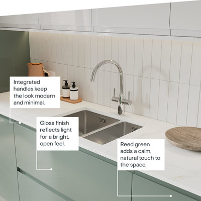 The Garcinia kitchen features gloss slab doors with integrated handles in a calming green tone for a bright, modern look.