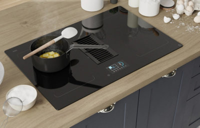 A close up of Artemisia midnight blue kitchen shaker with integrated hob with light wood worktops.
