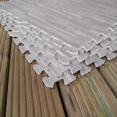 https://media.diy.com/is/image/KingfisherDigital/12-piece-grey-wood-effect-eva-foam-floor-protective-mats-60x60cm-each-set-gyms-garages-camping-covers-4-32-sqm-46-5-sq-ft-~5060907220074_05c_MP?$MOB_PREV$&$width=618&$height=618