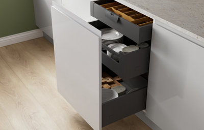 The Garcinia kitchen in gloss dove grey, featuring sleek slab cabinet doors with integrated handles and deep pull-out drawers for smart, organised storage.