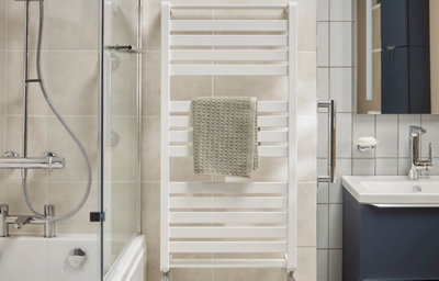 Family bathroom, close-up of the white towel radiator.