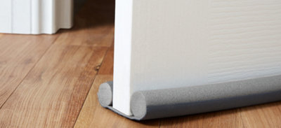 Draft excluder comprised of two foam tubes joined at the bottom sitting either side of a door.