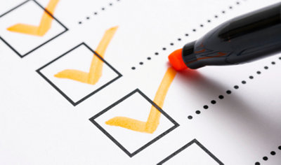 Pen marking a tick on a checklist.