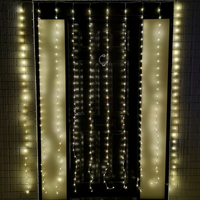 300 LED light twinkle led lights, clear wire, silver wire,300 twinkle  curtain lights, 8 Function Curtain Lights Combination, In Waves,  Sequential, Slo-Glo, Chasing/Flash, Slow Fade, Twinkle/Flash, and Steady  On, warm white Parties