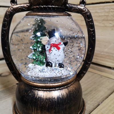 20cm Premier Christmas Water Spinner Antique Effect Hurricane Lantern with Snowman Scene Battery Operated