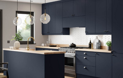 The Ethos kitchen, featuring sleek dark blue cabinets, chrome fixtures and cupboard handles, and light wood-effect countertops.