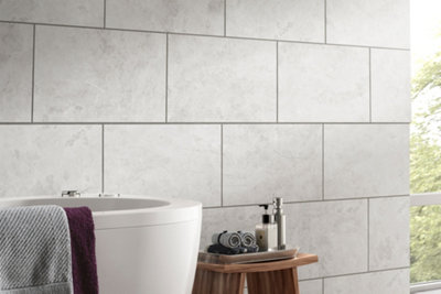 Large light grey wall tiles in a bathroom.