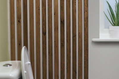 Slatted wall panelling with thin strips of wood installed vertically in a line.