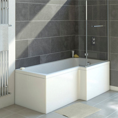 L shaped shower bath that is wider at the end where the shower valves are installed. Bath has a shower screen at the wider end and is installed in the corner between two tiled walls.