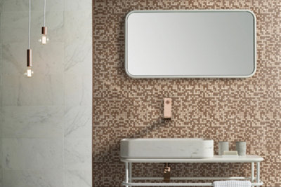 Metallic mosaic tiled bathroom wall with large white wall mirror and white basin.