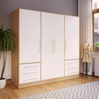 Modern wardrobe with finger pull design. Wooden wardrobe with light gray  cabinet doors. Modern furniture Stock Photo