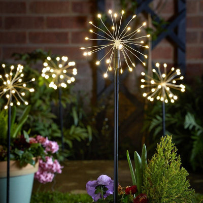 4 x Starburst Stake Lights Battery Powered Home or Garden Pathway Lawn Patio Lighting with Warm White LED s Timer Function