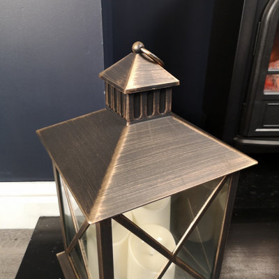 https://media.diy.com/is/image/KingfisherDigital/40cm-battery-operated-triple-lantern-with-timer-in-bronze~5056589114848_05c_MP?$MOB_PREV$&$width=618&$height=618