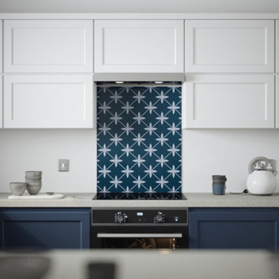White and blue kitchen with dark blue and white geometric patterned splashback.