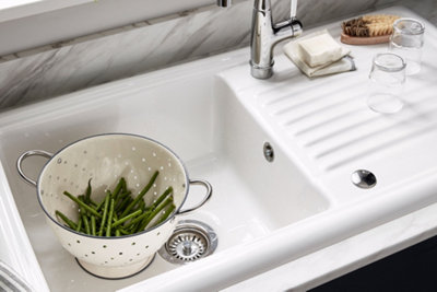 Cooke & Lewis Burbank Gloss White Ceramic 1 Bowl Sink & drainer installed on top of a white worktop.