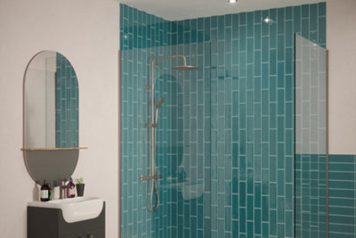 Green vertical metro tiles inside shower enclosure.