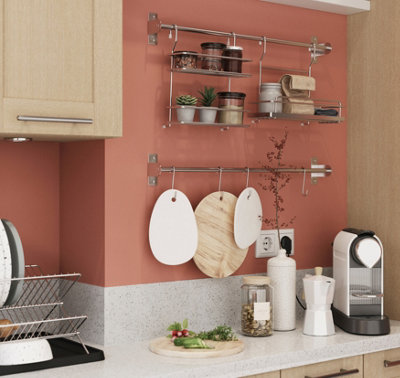 Wall mounted rails and hooks on kitchen wall, providing extra kitchen storage.