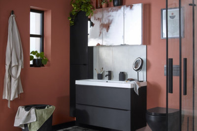 A bathroom with a wall-mounted vanity unit, a large bathroom mirror cabinet and a tall wall-mounted bathroom cabinet.