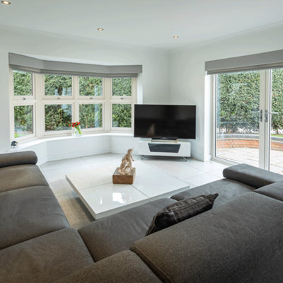 Modern style, double aspect lounge with large made to made measure windows and patio doors with calming colours.