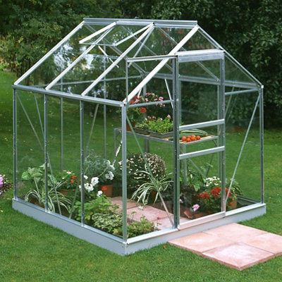 Glass greenhouse for growing plants in the garden