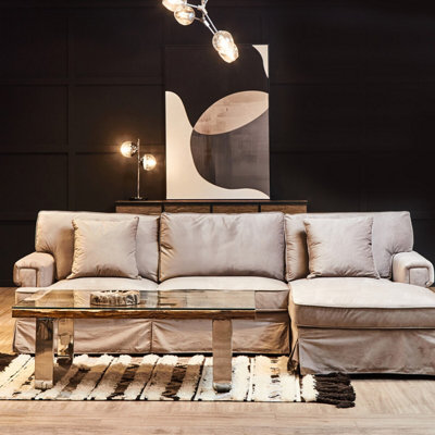 Orsina Three Seat Grey Velvet Chaise SofaGrey Velvet Upholstery With Wooden BasePadded Arms And Extended Chaise from B&Q