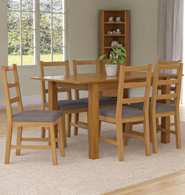 Hallowood Furniture Camberley Oak Butterfly Extending Dining Table With 6 Ladder Back Chairs In Light Grey Fabric Seats from B&Q