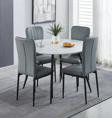 Hallowood Furniture Cullompton Large Round Dining Table 120Cm With 4 Light Grey Faux Leather Chairs from B&Q