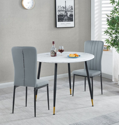 Hallowood Furniture Finley Small Round Dining Table In White Marble Finish With 2 Light Grey Faux Leather Chairs from B&Q