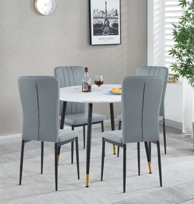 Hallowood Furniture Finley Small Round Dining Table In White Marble Finish With 4 Light Grey Faux Leather Chairs from B&Q