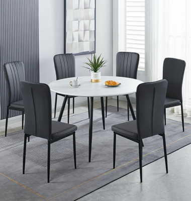 B&Q -  Cullompton Large Round Dining Table 120CmWhite Marble Effect TopWith 6 Black Faux Leather High Back Chairs