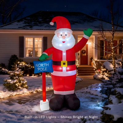 Shatchi 6Ft Inflatable Hand Waving Santa Clause With North Pole Sign Board Pre Lit Mains Powered White Led Lights Christmas from B&Q