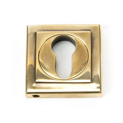From The Anvil Aged Brass Round Euro Escutcheon (Square) from B&Q