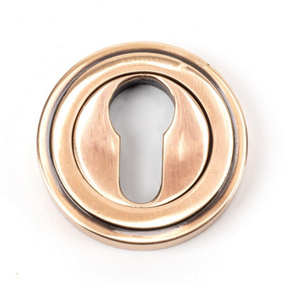 From The Anvil Polished Bronze Round Euro Escutcheon (Art Deco) from B&Q