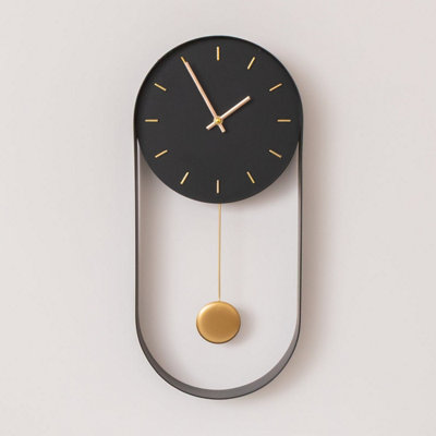 Melody Maison Black & Gold Pendulum Metal Analogue Wall Clock20Cm X 55Cm from B&Q