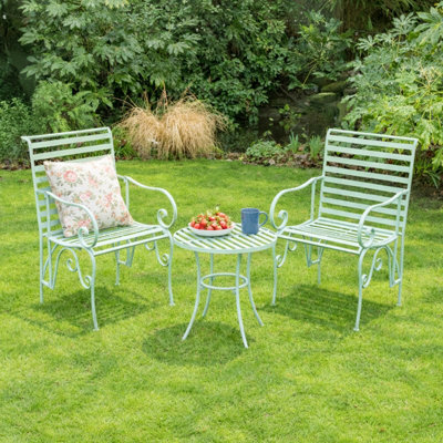 Melody Maison Ornate Metal Sage Green Round Garden Table & Set Of 2 Ornate Garden Chairs from B&Q