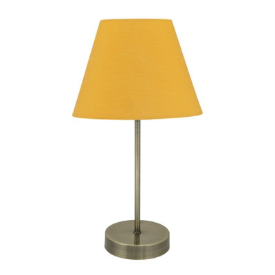 First Choice Lighting Antique Brass Stick Table Lamp With Ochre Fabric Shade from B&Q