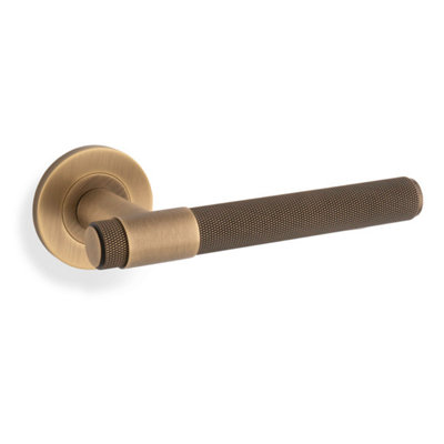 Alexander & Wilks Knurled Kingstone Lever On Round RoseAntique Brass from B&Q