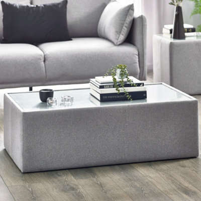 Julian Bowen Rohe Grey Rectangular Fabric Upholstered Coffee TableGlass TopHeight: 36 X Width: 110 X Depth: 60Cm from B&Q