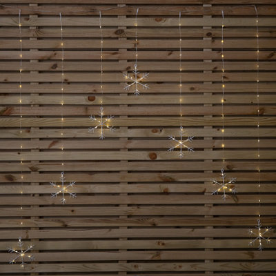Samuel Alexander 1.2M Battery Operated Snowflake Christmas Curtain Lights With 147 Warm White Leds from B&Q