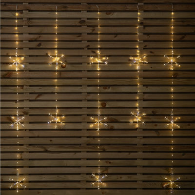 Samuel Alexander 1.2M X 1.3M Light Up Twinkling Snowflake Christmas Curtain Light With Warm White Leds from B&Q