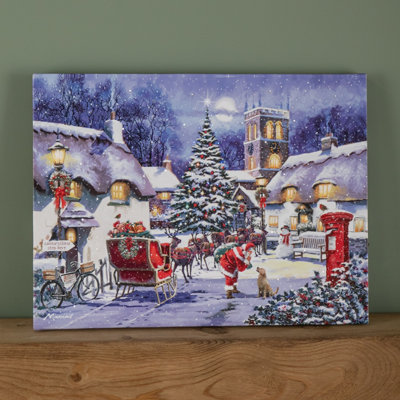 Samuel Alexander 40 X 30Cm Battery Operated Light Up Fibre Optic Santa And Village Christmas Wall Canvas from B&Q
