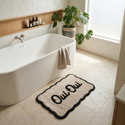 Allure Bath Fashions Oui Oui Slogan Scalloped Bath MatBeige/black from B&Q