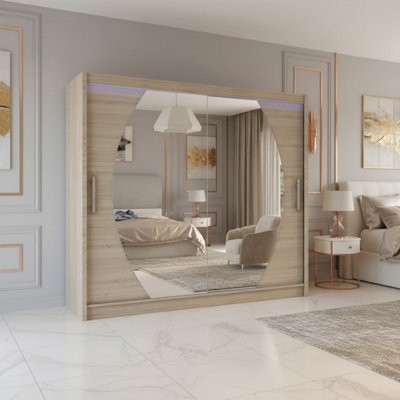 Bega Iv 180 Sliding Door Wardrobe Modern Bedroom Storage With Mirror Hanging Rail And Shelves In Sonoma With Led from B&Q