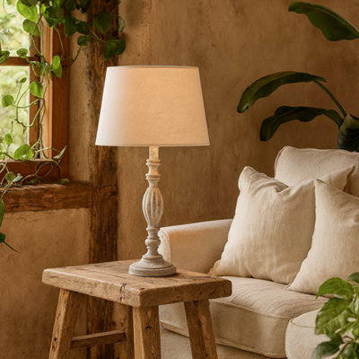 Wyld Haus Milan Distressed Grey Carved Wooden Table Lamp With Cream Linen Shade from B&Q
