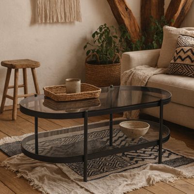 Wyld Haus Featheroak Grey Smoked Glass Oval Coffee Table With Black Metal Legs from B&Q