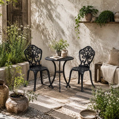 Wyld Haus Rirara 3-Piece Black Cast Aluminium Floral Bistro Set2 ChairsRound Table With 48mm Parasol Hole from B&Q