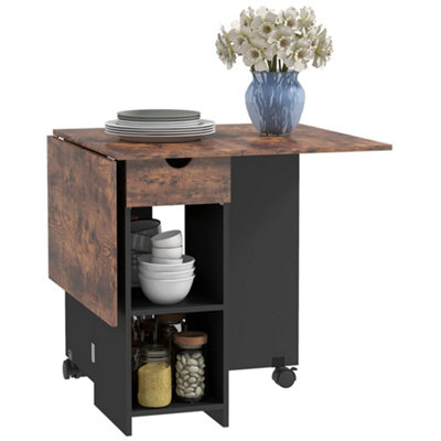 Wyld Haus Rustic Brown Folding Drop Leaf Dining Table With Drawer And Storage ShelvesSeats 4 from B&Q